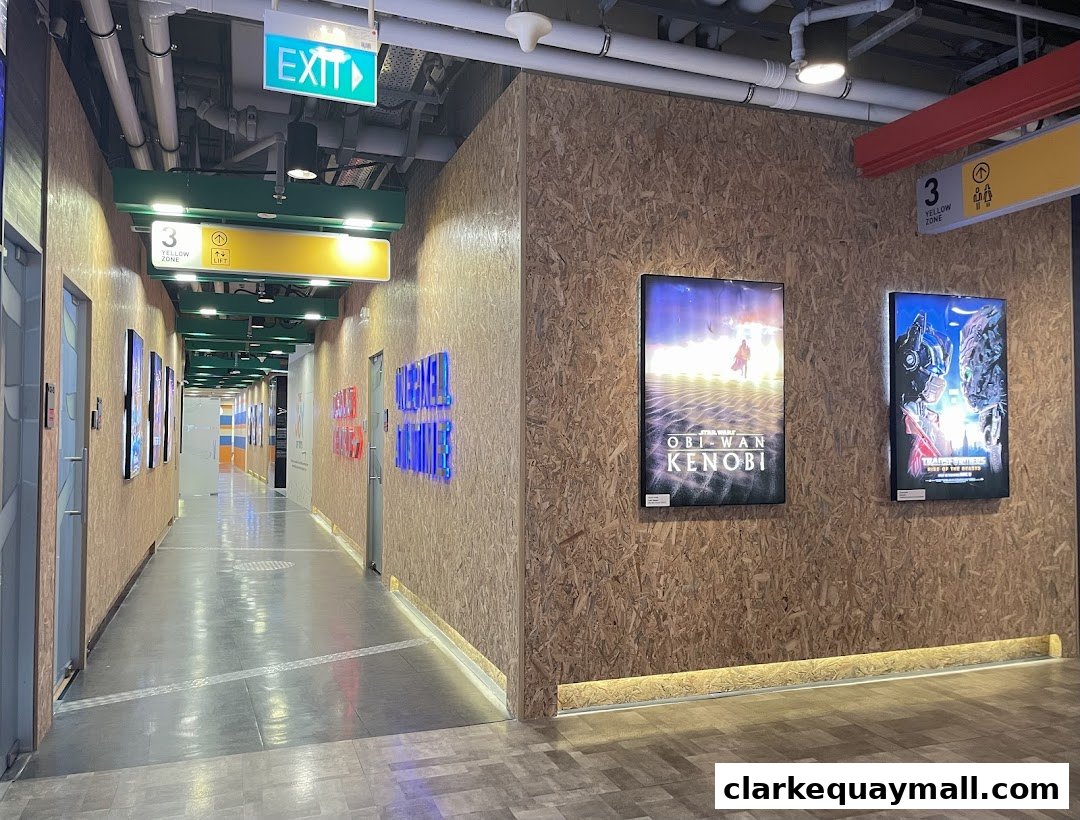 A hallway with movie posters and signage for 3dsense Media School.