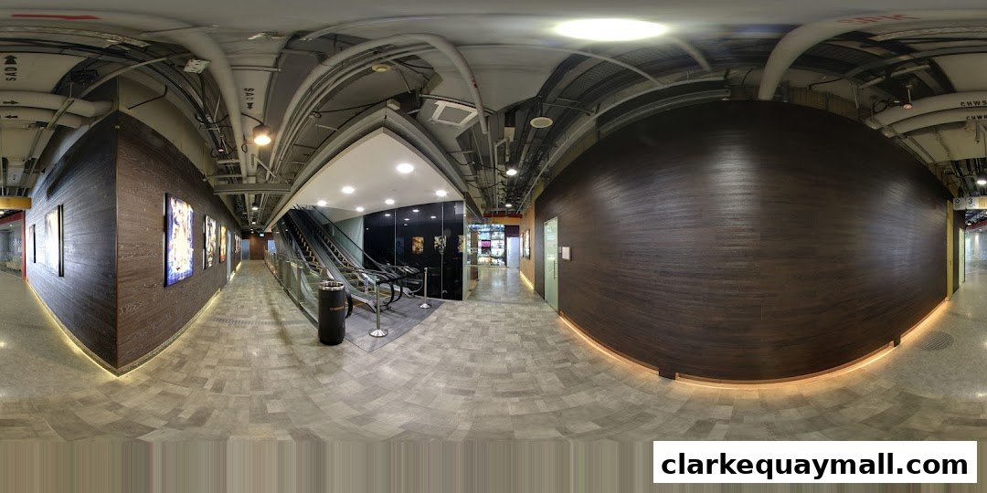 A modern hallway with wood-paneled walls, artwork, and escalators leading to different levels.