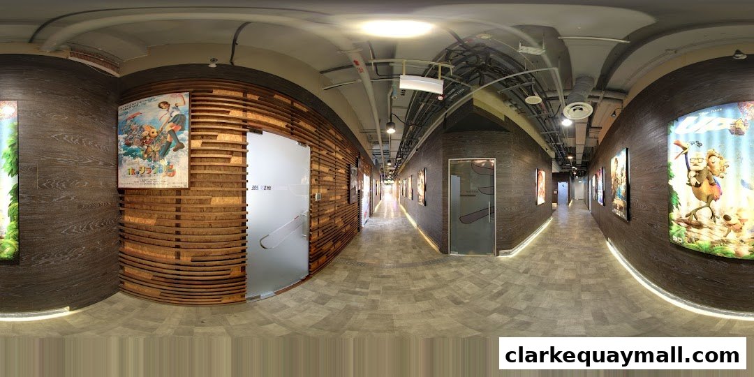 A modern hallway with wooden accents, movie posters, and frosted glass doors.
