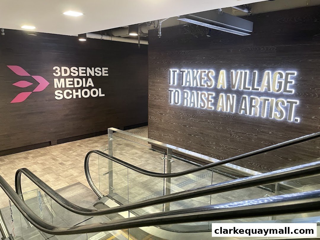 The entrance to 3DSENSE Media School with a motivational quote on the wall.
