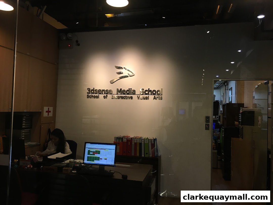 The reception area of 3dsense Media School with its logo and a staff member at a desk.