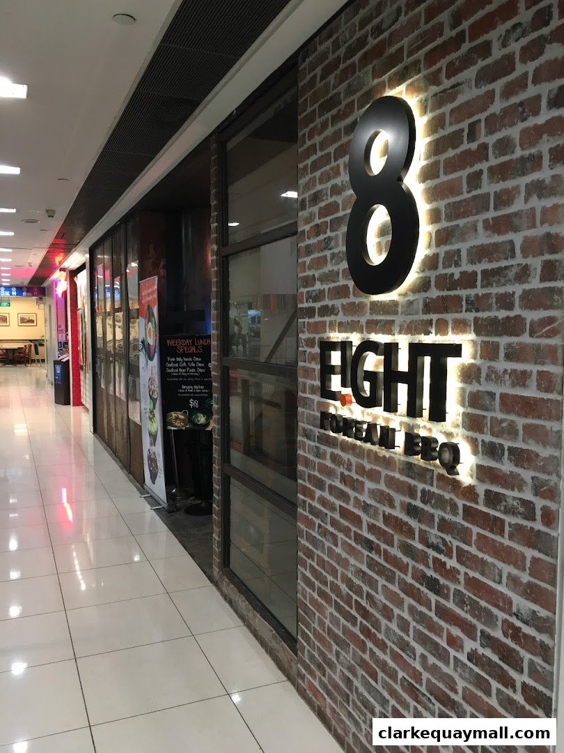 The exterior of '8 Korean BBQ' restaurant with a brick facade and illuminated signage.