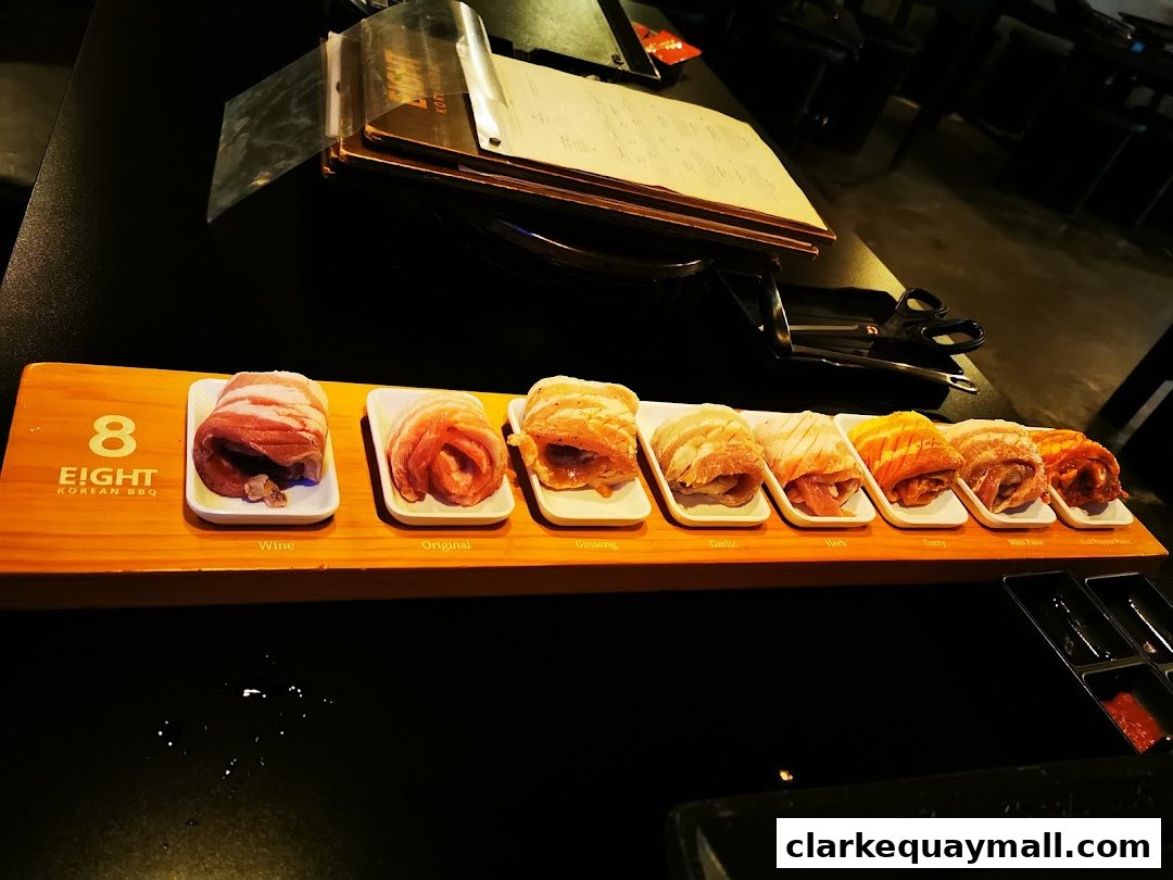 A selection of marinated meats arranged on a wooden board at 8 Korean BBQ.