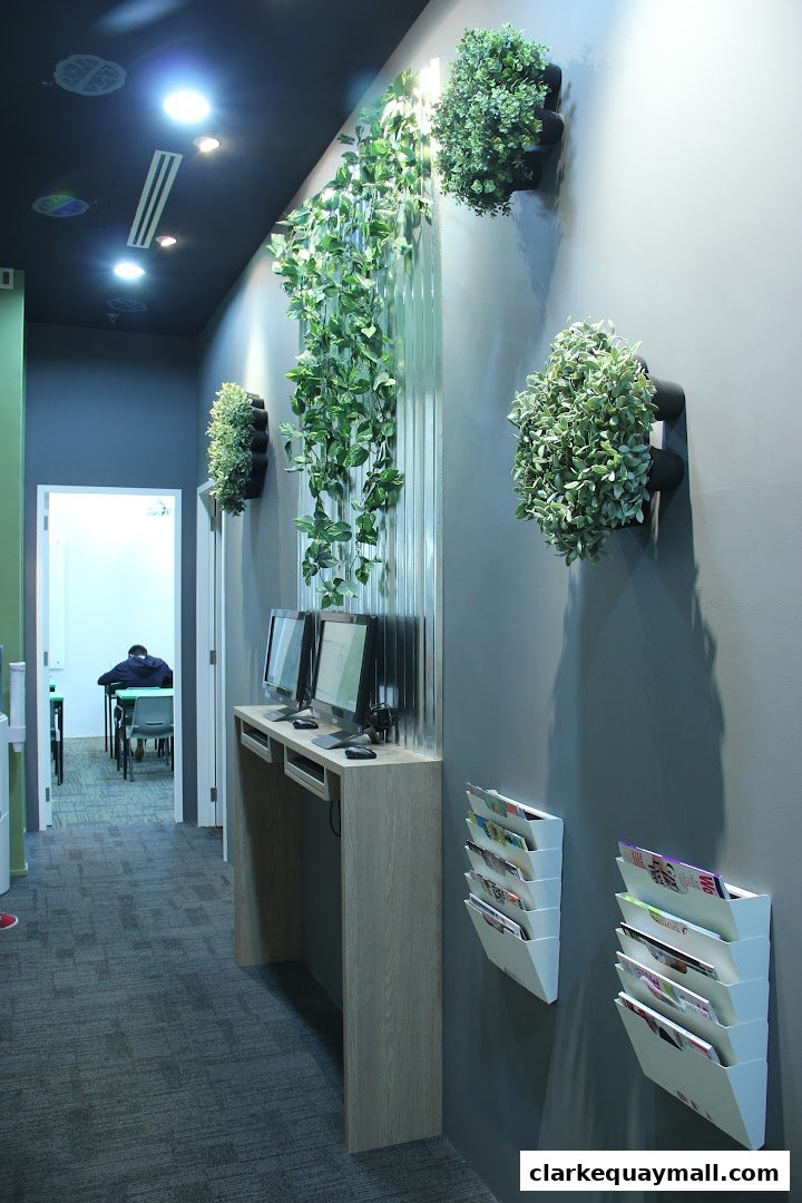 Interior view of Ace Brainery with computers, plants, and magazines on the wall.