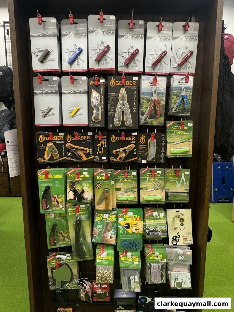 A display of various outdoor and camping tools, including Swiss Army knives and multi-tools.