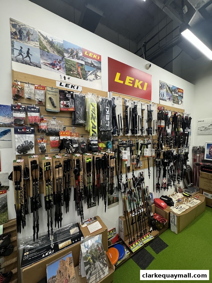 A retail shop interior displaying a wide selection of hiking and trekking poles.