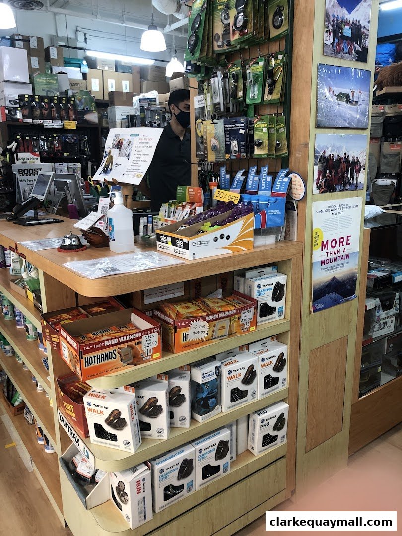 Interior of an outdoor adventure gear shop with various products displayed on shelves.