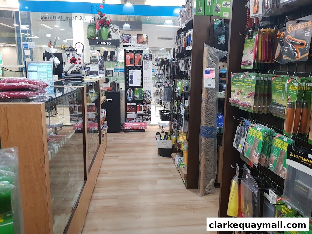 Interior view of an outdoor and travel gear shop with merchandise displayed on shelves and racks.