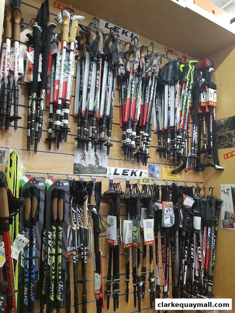 A wall display featuring a wide selection of Leki brand trekking and ski poles.