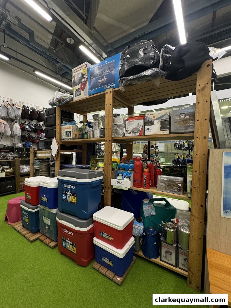 Shelves stocked with camping gear, coolers, bags, and outdoor equipment.