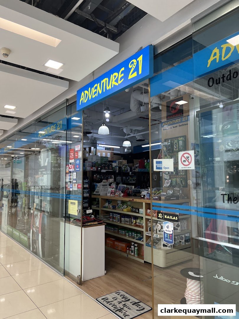 The exterior of Adventure 21, an outdoor and travel outfitter shop, showcasing its merchandise.