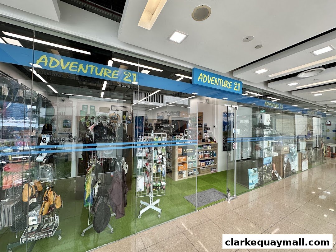 The storefront of Adventure 21, an outdoor and travel outfitters shop, showcasing various gear.