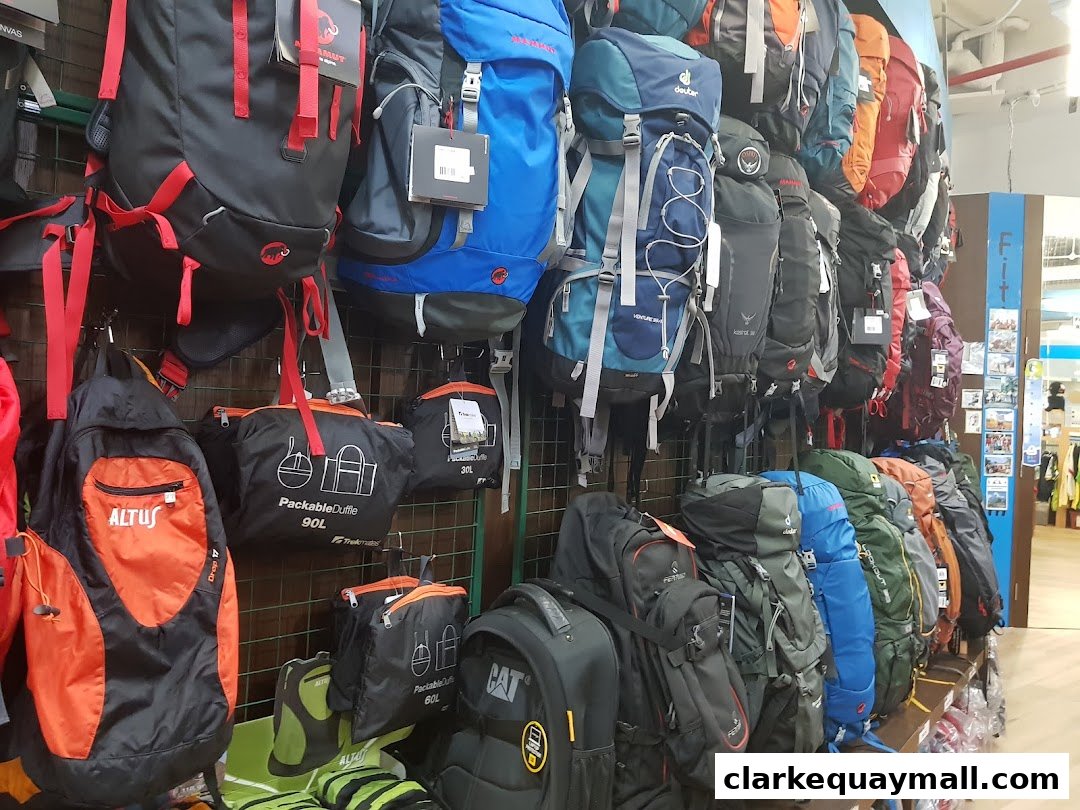 A wide selection of backpacks and duffel bags displayed on shelves and hooks.