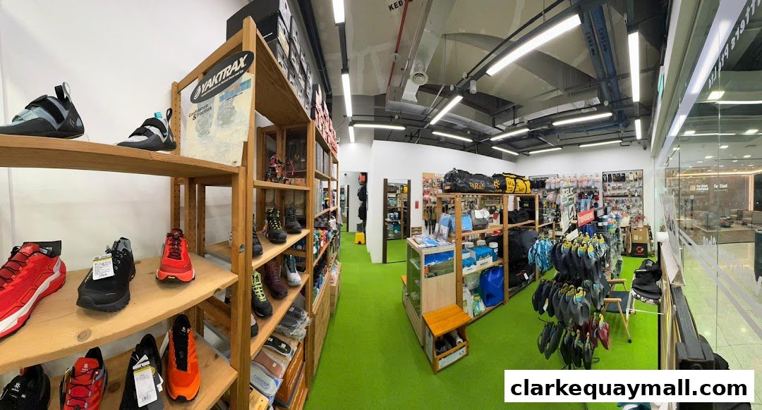 Interior view of an outdoor adventure gear shop, showcasing footwear, bags, and accessories.