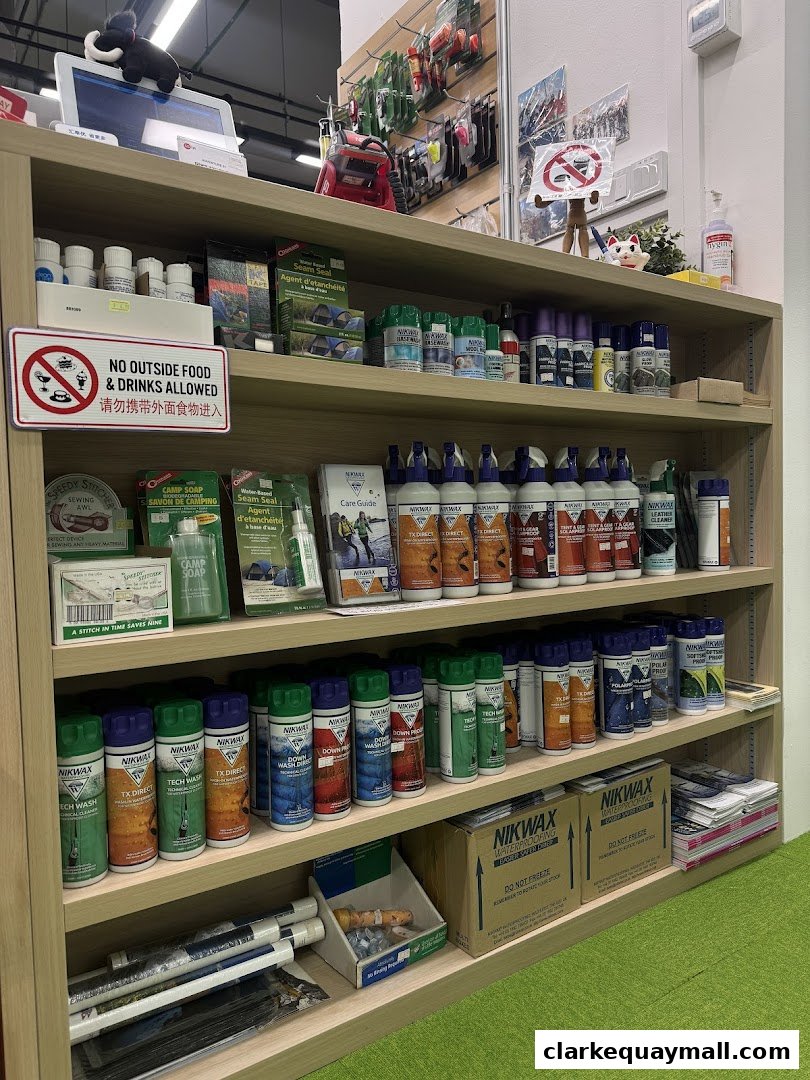 Shelves stocked with outdoor gear cleaning and repair products, including sprays and sealants.