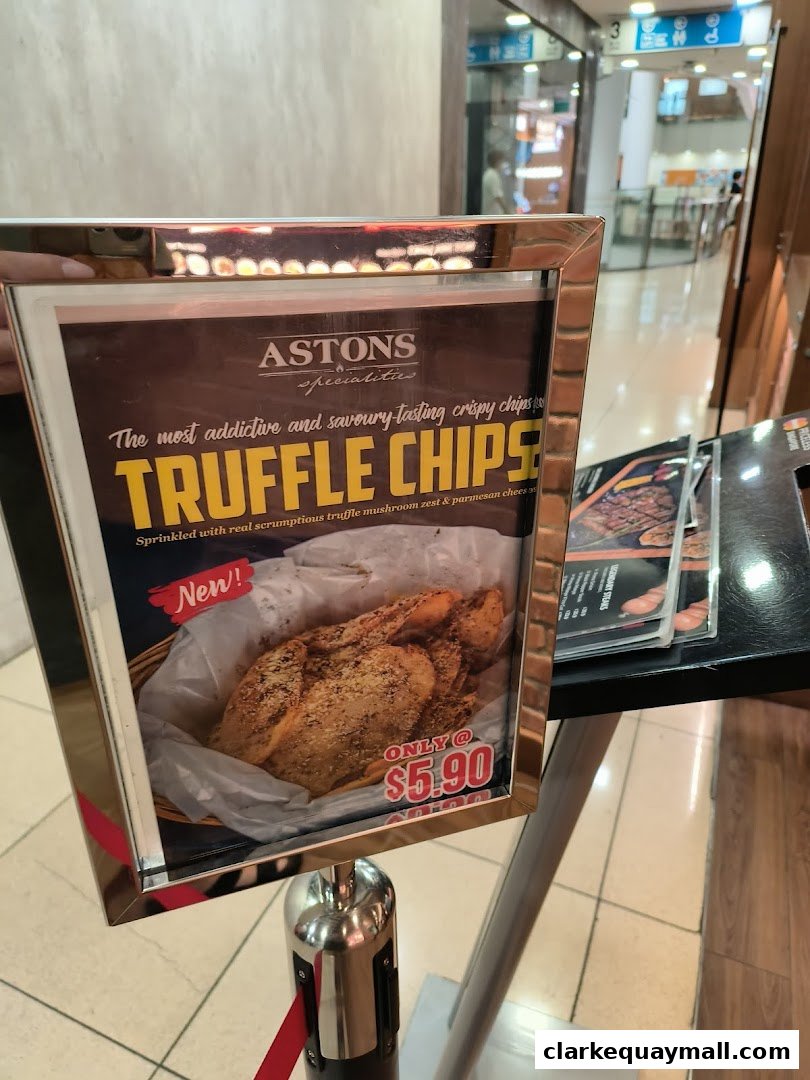 A sign advertising Astons Specialities' new Truffle Chips for $5.90.