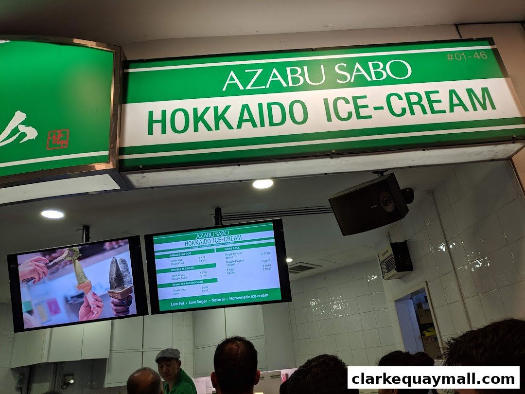 A sign and menu board for Azabu Sabo Hokkaido Ice-Cream, showing ice cream flavors and prices.