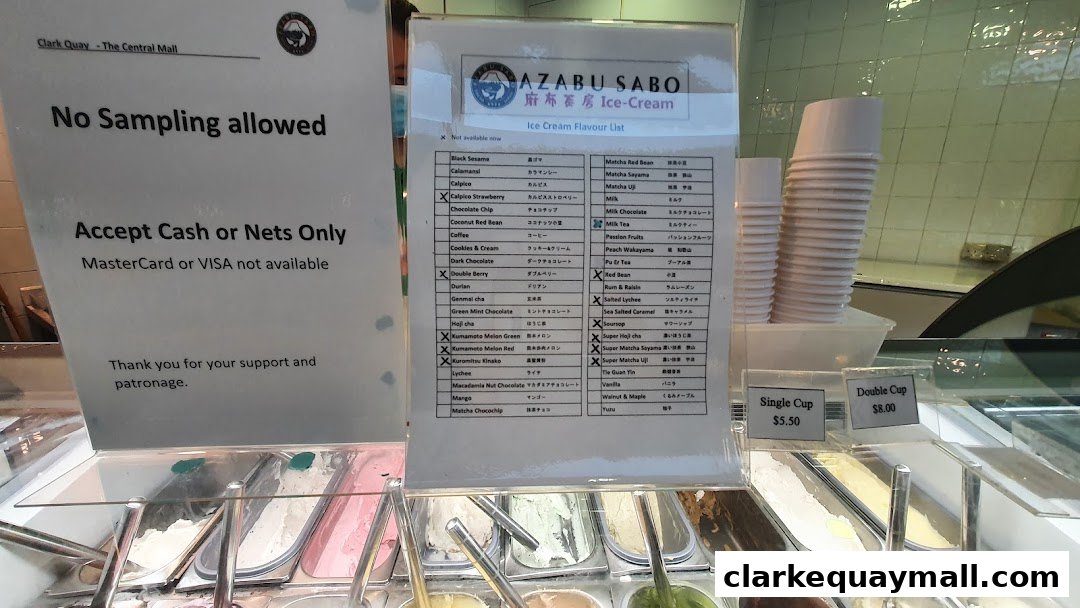 An ice cream shop display with a flavor list and pricing for single and double cups.