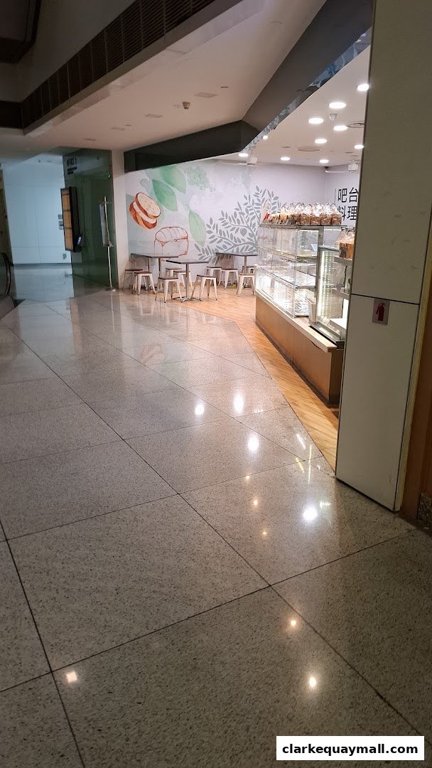 Interior view of Barcook Bakery with display cases and seating area.