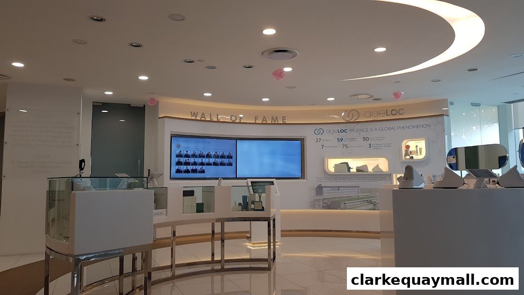 Interior of a modern retail space with displays and screens showcasing products and achievements.