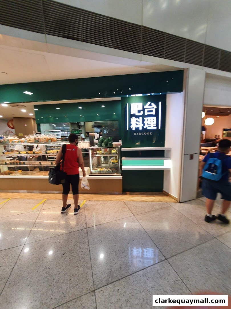 A Barcook Bakery shop front with display cases filled with baked goods and a prominent sign.