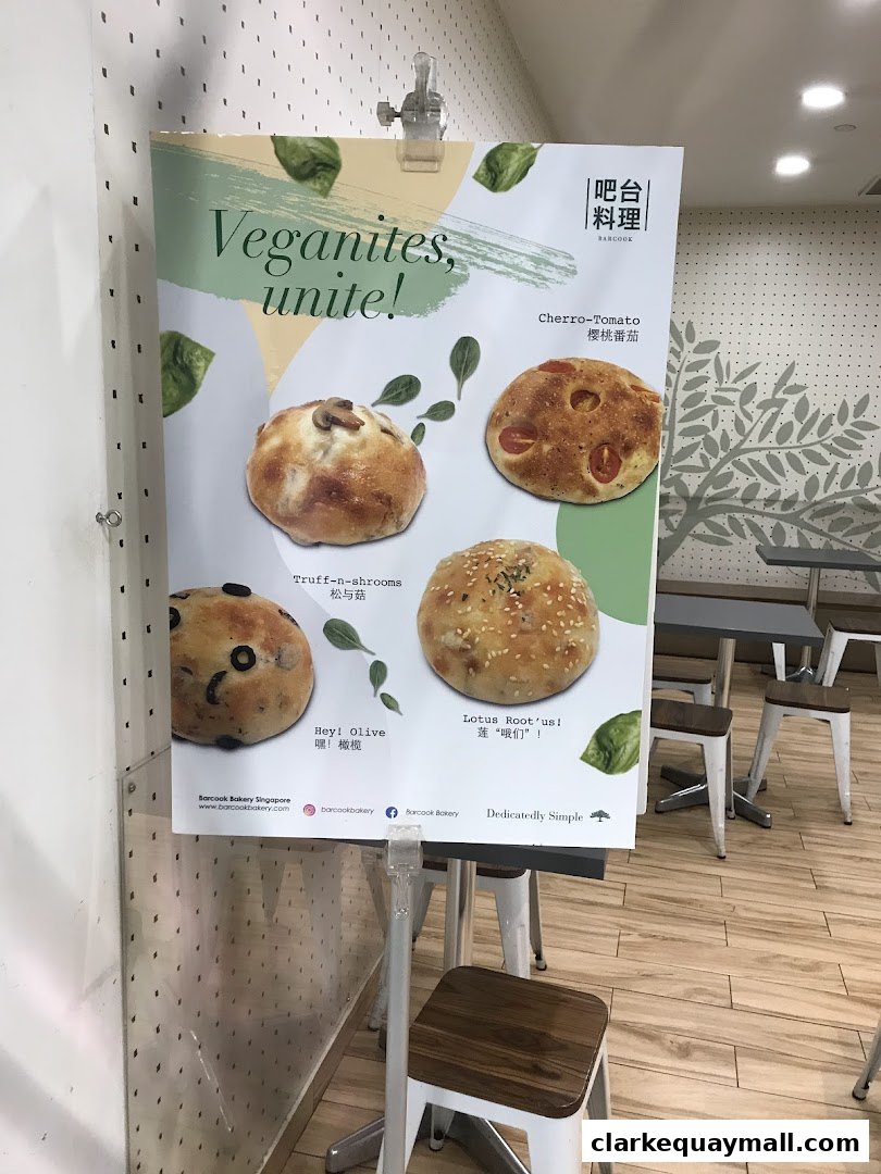 A poster advertising vegan baked goods from Barcook Bakery, featuring four different types of bread.