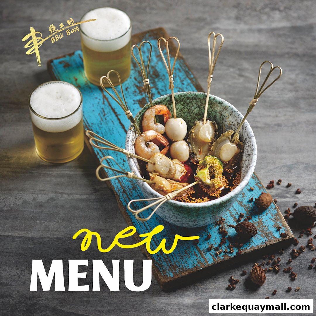 A bowl of assorted skewers with shrimp, scallops, and quail eggs, served with beer.