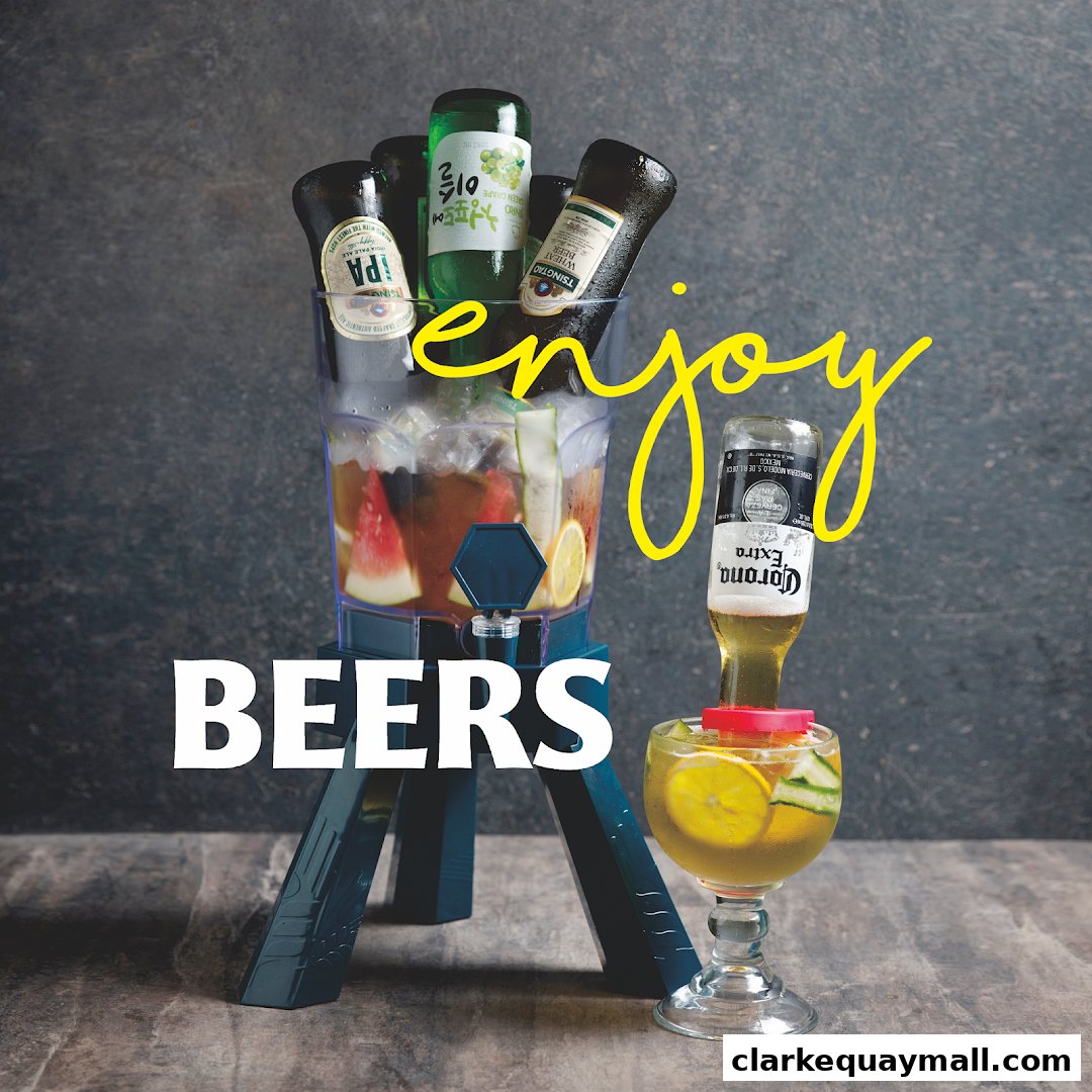 A beverage dispenser filled with beers, ice, and fruit, with a Corona bottle in a glass.