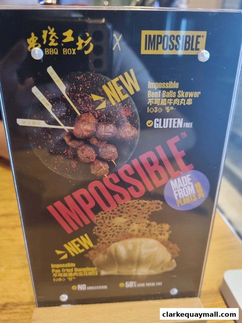 A menu board showcasing new Impossible Beef Balls Skewers and Pan-fried Dumplings.