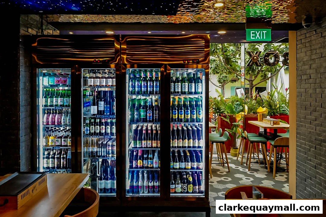 A well-stocked beverage cooler with various bottles and cans, leading to a dining area with tables and chairs.