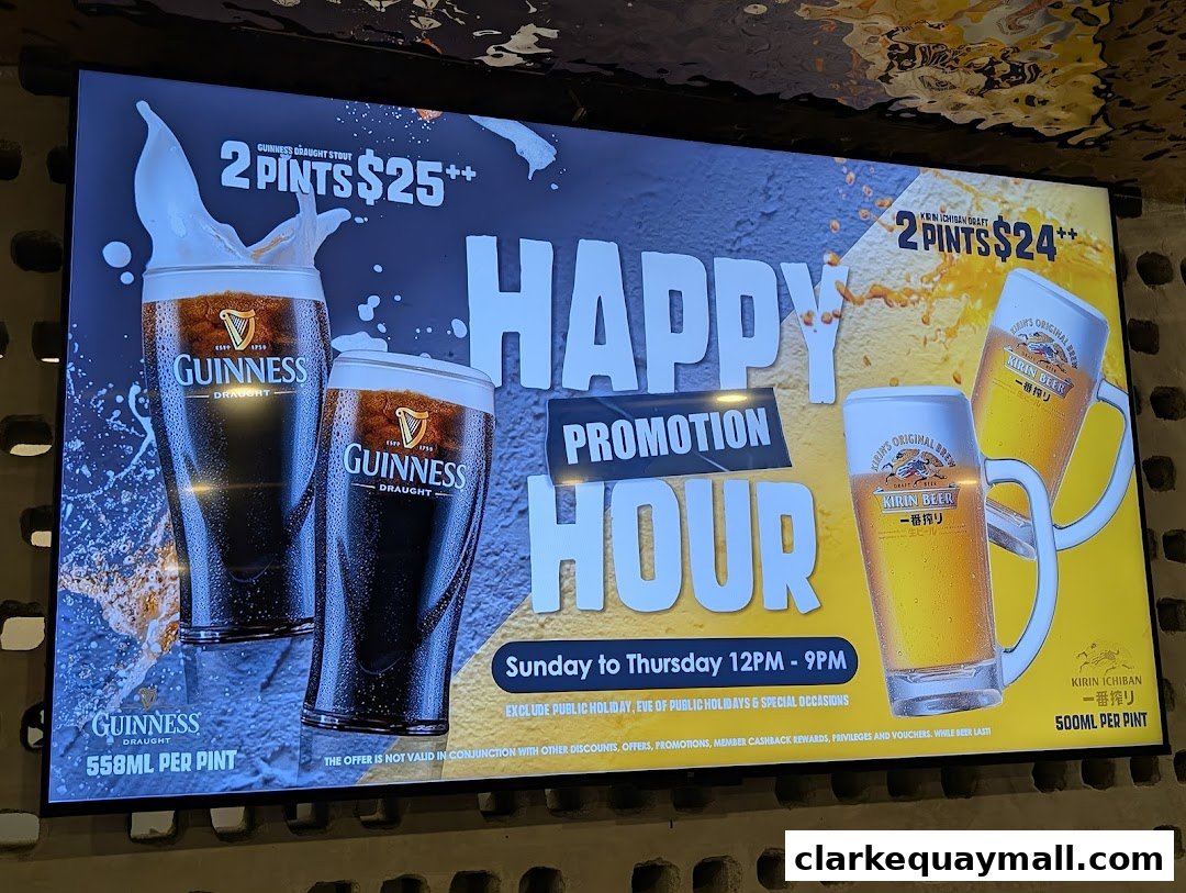 A digital display advertises a happy hour promotion for Guinness and Kirin Ichiban beer.