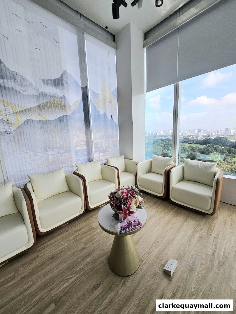A waiting area with cream-colored chairs and a floral centerpiece, overlooking a city view.