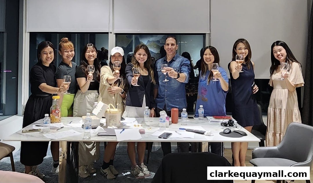 A diverse group of people raising glasses in a toast around a table.