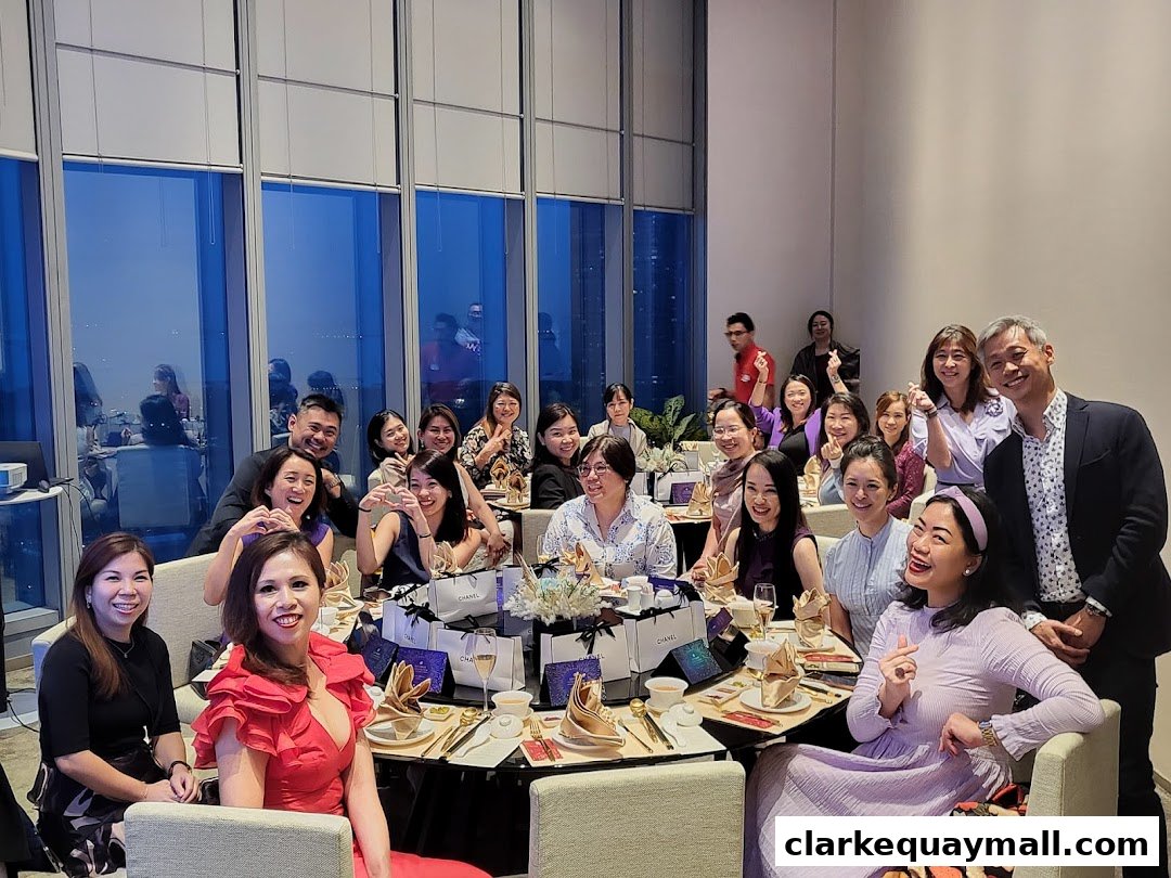 A group of people smiling and posing for a photo at a formal dinner event.
