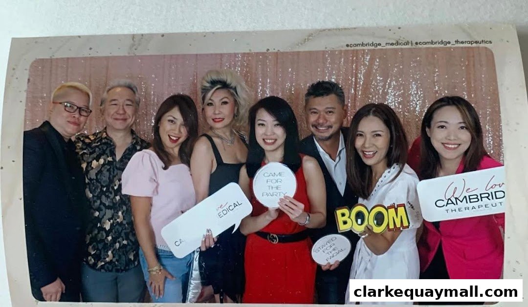 A group of people posing for a photo with props at an event.