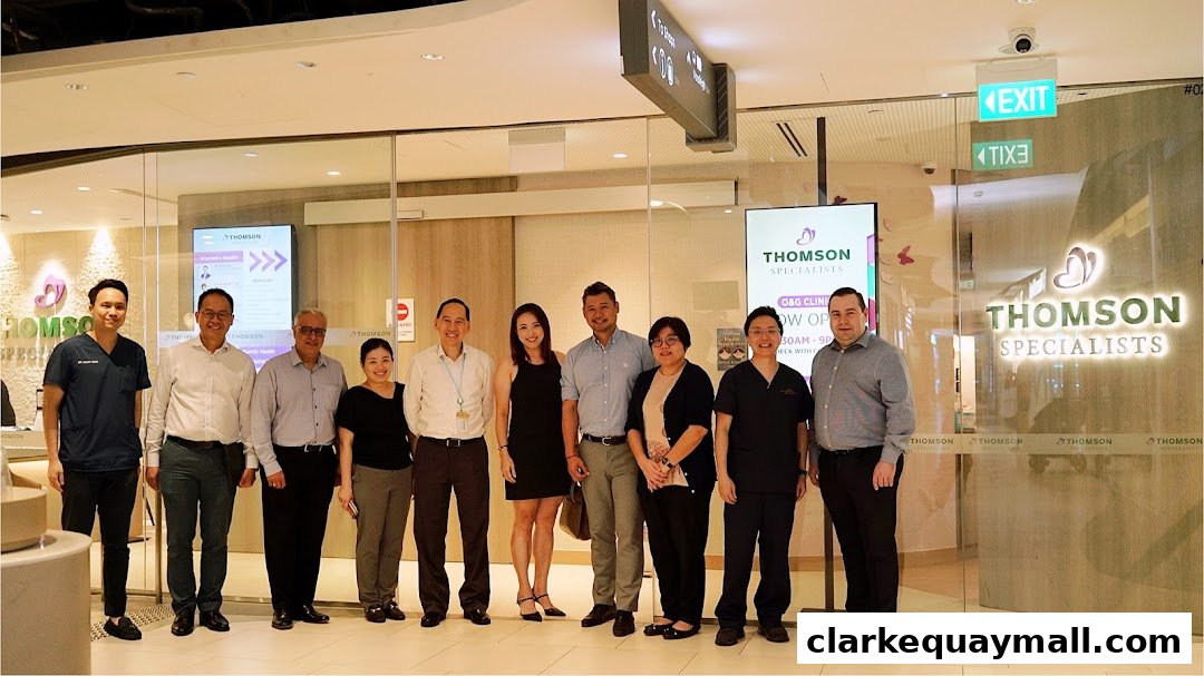 A group of medical professionals posing in front of a Thomson Specialists clinic.