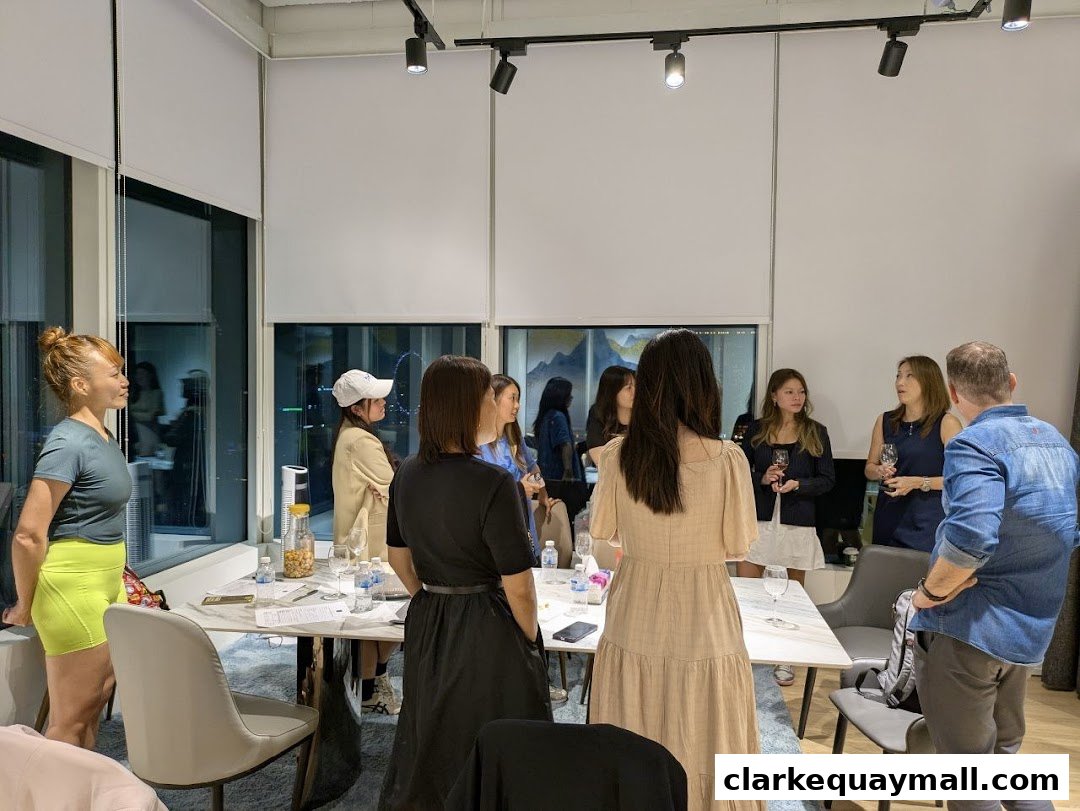 A group of people gathered around a table in a modern office or event space.