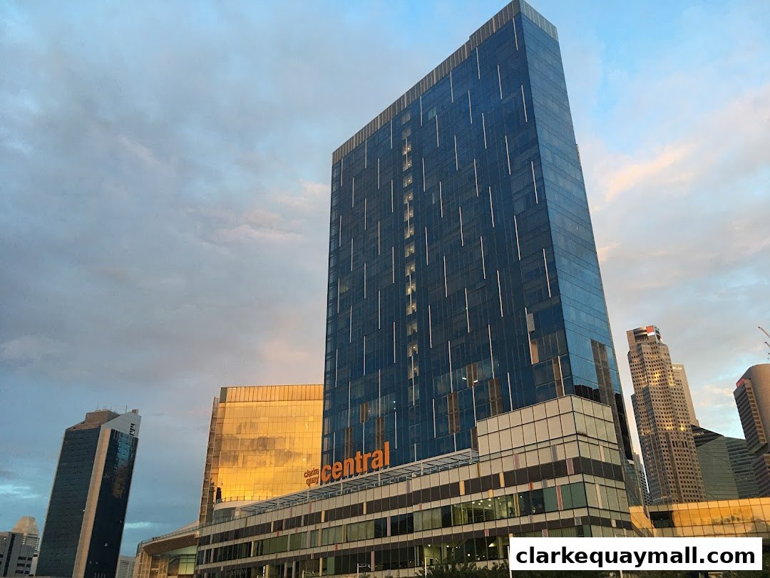 Modern skyscrapers in a city skyline at sunset with clouds.