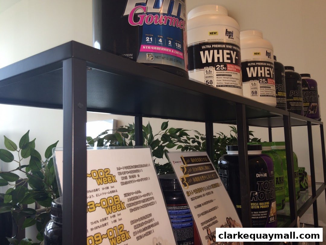 Shelves filled with various protein powder containers and informational flyers.