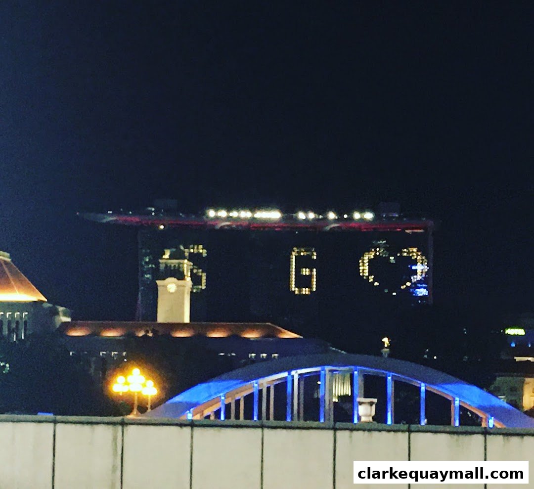 Night view of a city skyline with illuminated buildings and a bridge.