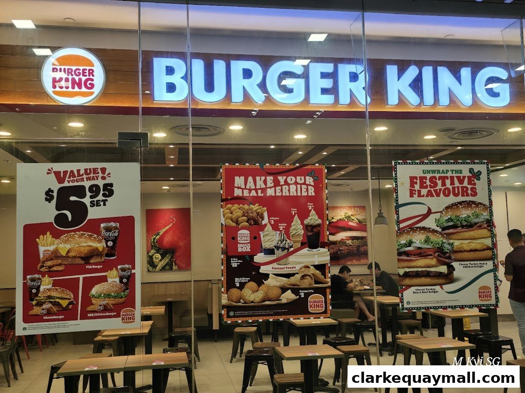 Burger King storefront with promotional posters and indoor seating visible through the glass.