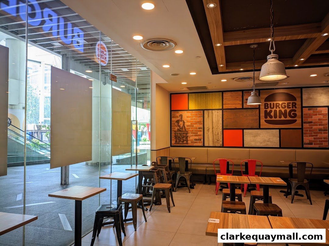 Interior of a Burger King restaurant with seating and branded wall decor.