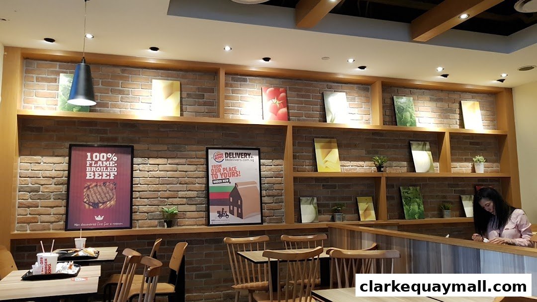 Interior of a Burger King restaurant with brick walls, shelves, and seating.