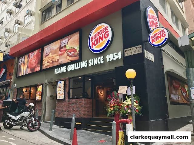 Burger King restaurant exterior with prominent signage and food displays.