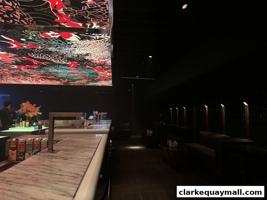 Interior of a dimly lit bar with a decorative ceiling and a marble bar counter.