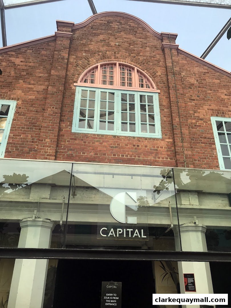 The exterior of Capital Zouk Singapore, a brick building with distinctive windows and signage.