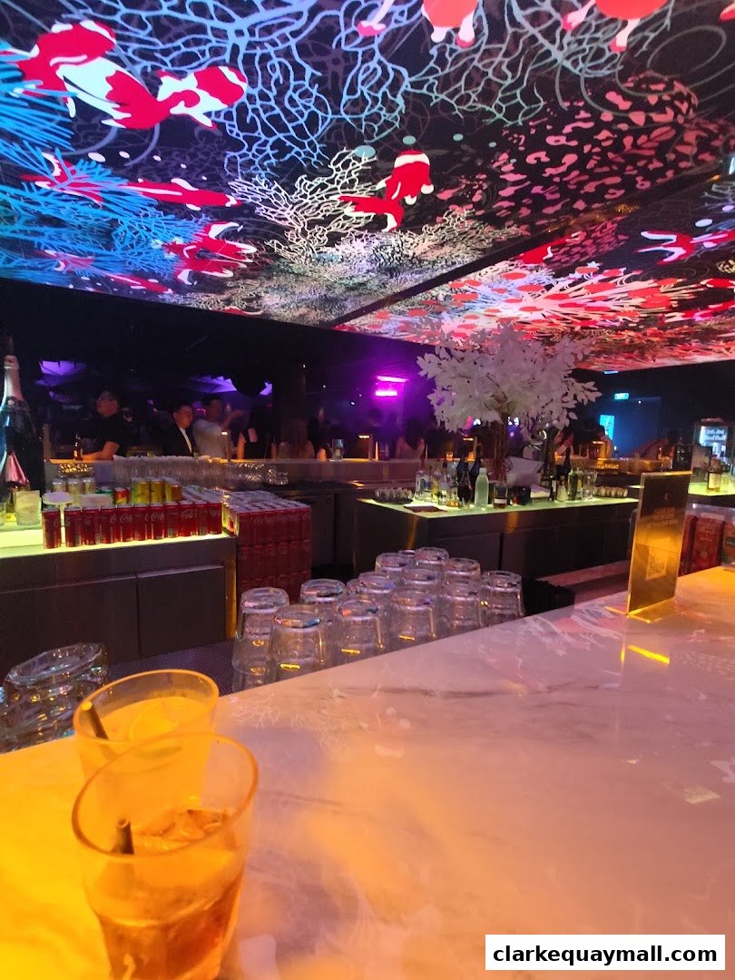 Interior of a bar with a vibrant, artistic ceiling and drinks on the counter.