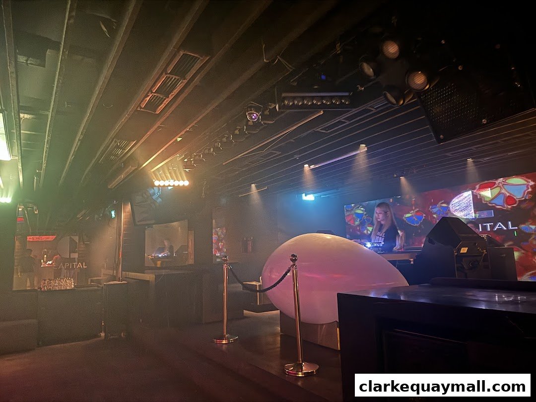 A DJ performing at Capital Zouk Singapore with a large balloon and stage lighting.