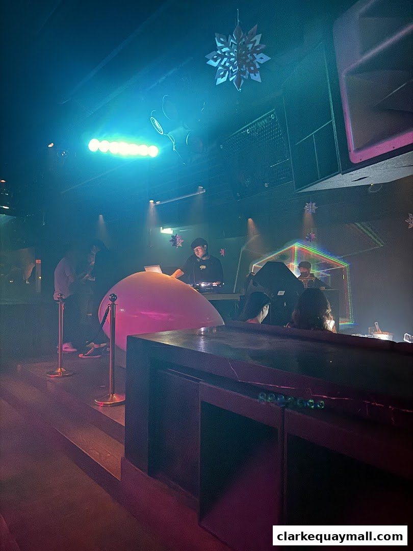 A DJ performs at Capital Zouk Singapore with a large pink balloon and festive decorations.