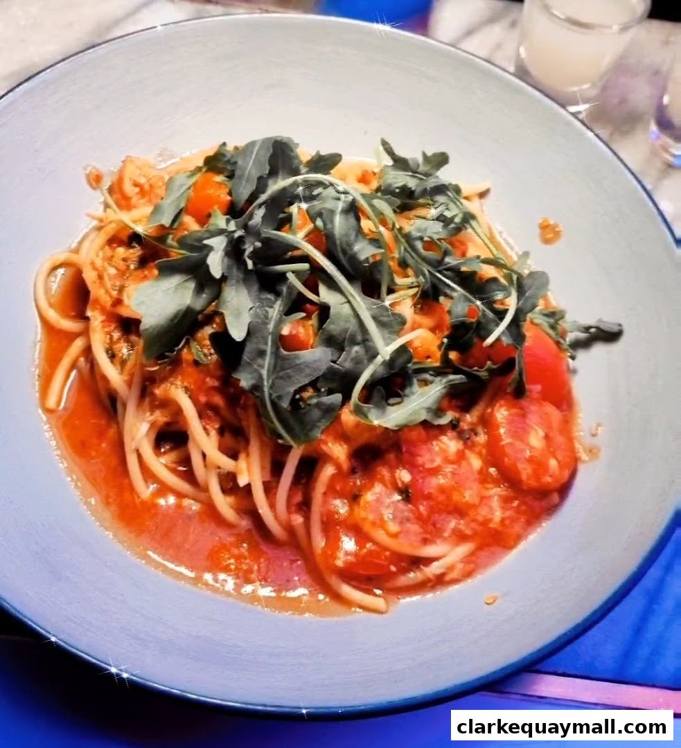 A close-up shot of a delicious pasta dish with tomato sauce and arugula.